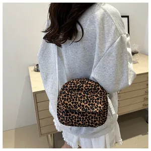 Detailed macro view of the leopard print crossbody bag with fabric texture and zipper