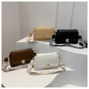 Group display of French-style crossbody bags with colorful patterned wide straps