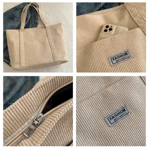Detail view of corduroy tote bag showing zipper closure, inner lining and exterior pocket