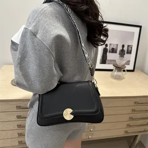 French style black pebble leather shoulder bag with gold clasp and geometric strap
