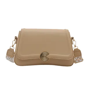Khaki leather shoulder bag with wide geometric strap and golden round buckle detail