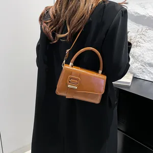 Brown patent leather shoulder bag with resin square buckle and top handle for women