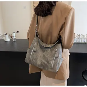 Detailed back view of a grey vintage hobo bag with vertical zippers and shoulder strap