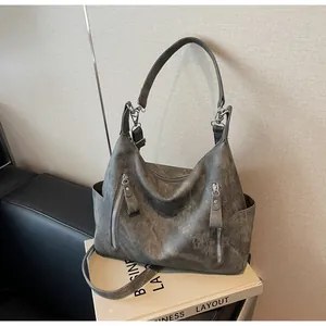 Detailed view of dark grey retro tote bag featuring matte texture and side pockets