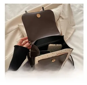 Internal view of brown faux leather crossbody bag showing space for phone and cards