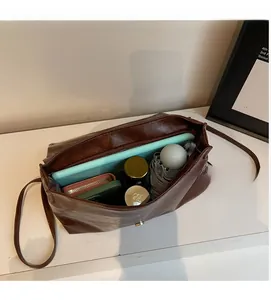 Top view of deep brown vintage leather bag interior showing spacious capacity for daily items