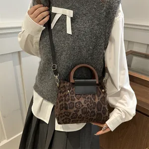 Vintage leopard print shoulder bag with retro wooden handle and crossbody strap