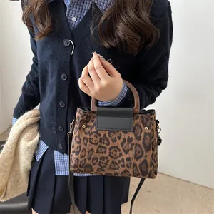 Vintage leopard print shoulder bag with resin handles and adjustable crossbody strap