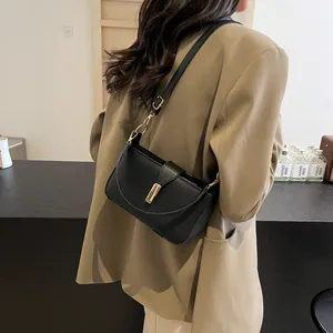 Minimalist black leather underarm shoulder bag with golden metal buckle for women