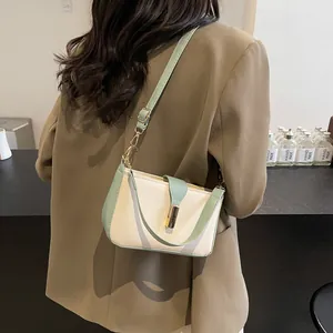 Minimalist beige and mint green shoulder bag with golden buckle and adjustable strap