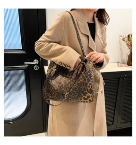 Leopard print tote bag styled with urban casual outfit showing its large capacity and strap
