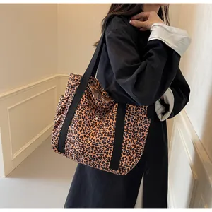 Leopard print canvas tote bag side view showing large capacity and reinforced black straps