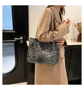 Close-up of a stylish leopard print tote bag styled with a classic autumn beige coat