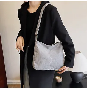 Detail of light grey corduroy tote bag showing striped texture and adjustable strap