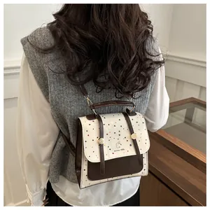 Detail of color-block vintage backpack with polka dot flap and rabbit logo detail