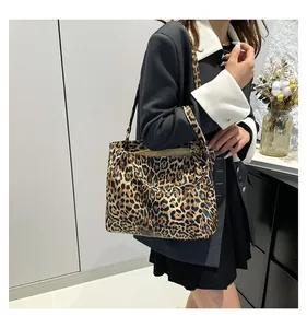 Detail of large leopard print tote bag with soft texture and slim shoulder straps