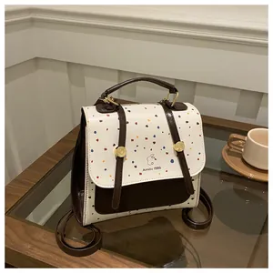 Detailed view of polka dot mini backpack on wooden table for an elegant afternoon vibe
