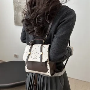 Chic cream and brown two-tone backpack with colorful polka dots and cute rabbit logo