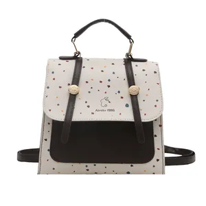 Chic polka dot mini backpack with contrasting brown straps and bunny graphic detail