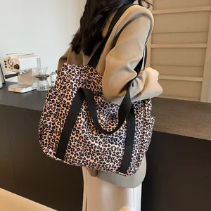 Large leopard print tote bag with black strap handles for stylish commuting and shopping