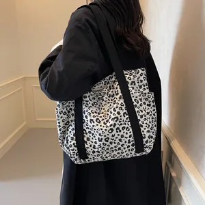 Large capacity canvas tote bag featuring black and white leopard print and black straps