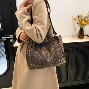 Minimalist leopard print tote bag with shoulder straps shown in a lifestyle setting