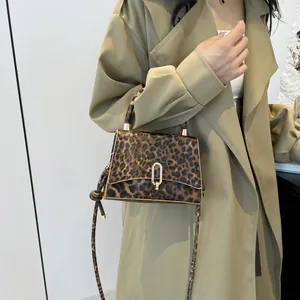 Fashionable leopard print crossbody bag with gold U-shaped buckle and leather texture