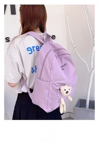 Détail d'un sac à dos en nylon lilas avec petit ours en peluche et imprimé LOVE