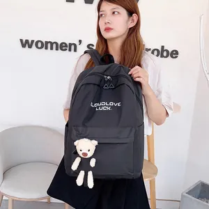 Sac à dos en toile noire minimaliste pour étudiantes avec pendentif d'ours blanc