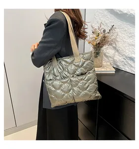 Champagne silver quilted tote bag with wavy stitching and canvas straps for daily commute