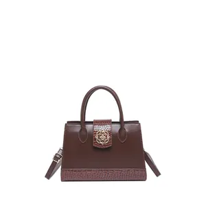 Classic dark brown crossbody bag with crocodile texture and golden flower lock