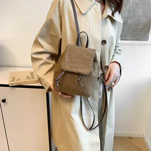 Brown fuzzy faux shearling backpack with flap cover and slim leather straps for women
