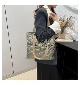 Chic metallic gold quilted tote bag with wide straps shown on shoulder in daily lifestyle