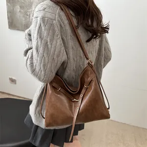 Brown vintage faux leather hobo bag with adjustable buckle straps and large capacity