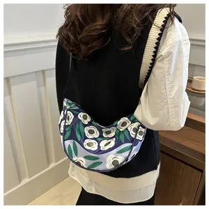 Detail view of crescent shoulder bag with floral patterns on casual polyester fabric