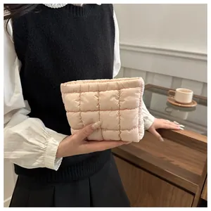 Detailed view of apricot quilted makeup bag with soft padded check pattern and square design