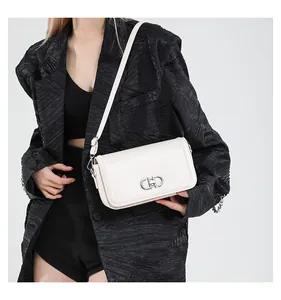 Detail of a creamy white rectangular flap bag with a silver round metal hollow buckle