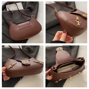 Detailed views of dark brown leather crescent bag with gold twist lock and inner dividers