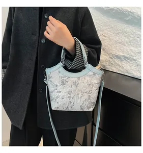 Detail of a New Chinese style floral silk embroidery bucket bag with light blue leather trim