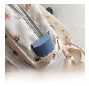Detail of tulip floral backpack showing functional side pocket and adjustable buckle