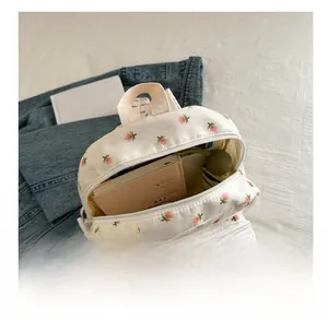 Spacious interior of floral Japanese backpack showing capacity for books and umbrella