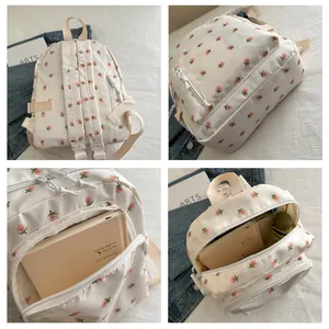 Detail view of floral backpack showing spacious interior compartment and zip pockets