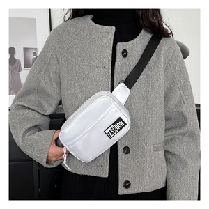 Close-up of white waterproof nylon crossbody bag featuring Fashion label and gray coat