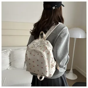 Close-up of a cream floral mini backpack featuring a charming pink flower print design