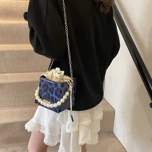 Blue leopard print mini bucket bag with pearl handle and metal chain shoulder strap