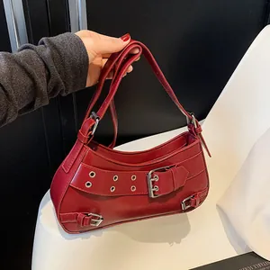 Red retro punk shoulder bag with silver metal eyelets and half-moon silhouette