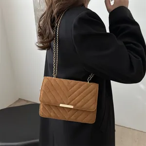 Brown quilted suede chain bag with V-shaped stitching and gold hardware for women