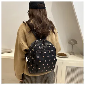 Detail view of the floral print backpack with adjustable buckles on the side panel