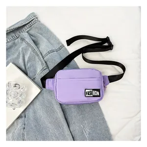 Detail of light purple nylon chest bag with adjustable black strap and fashion patch