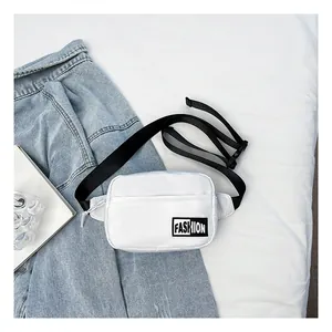 Close-up of white nylon crossbody waist bag with FASHION patch and adjustable black strap